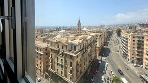 A cityscape with a prominent tower and dense urban buildings. - TORRE CANTORE 69 (GENOVA OVEST/PORTO)   GENOVABB.IT (GENOVA)