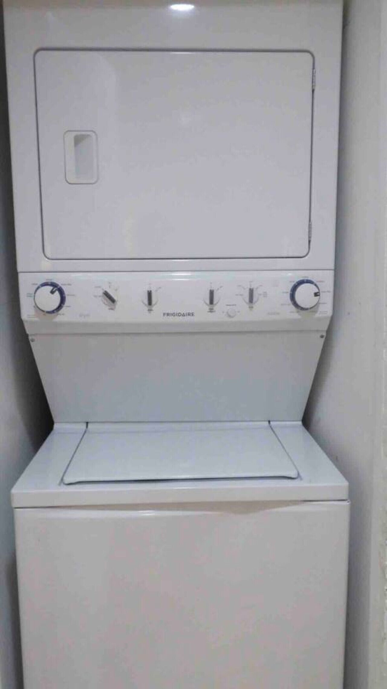 A white washing machine with a control panel and a door.