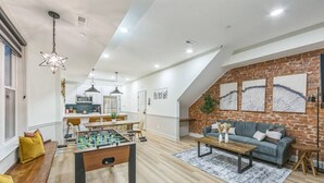A modern living room with a foosball table, a sofa, and a coffee table. - New 2/2 Across from Fairmount Park | 10 mins to DT (Philadelphia)