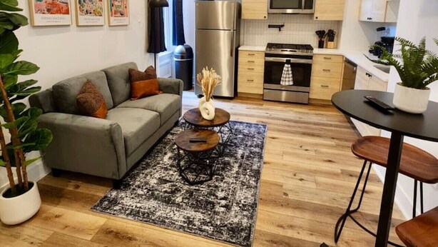 A compact living space with a sofa, coffee table, and a small dining area.