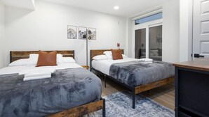 A hotel room with two beds, a desk, and a wardrobe. - 2BR w/Balcony Fairmount Park 10 mins to DT (Philadelphia)