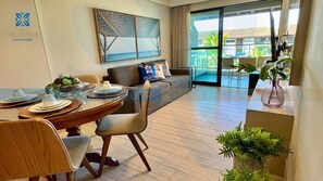 Ein modernes Wohnzimmer mit Essbereich, einer Couch und Blick ins Freie.