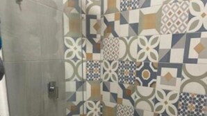 A bathroom with a shower area and a toilet. - Spanish Moon PV - # 9 Queen Room, refrig. , micro.,coffee maker, pool, WiFi, TV (Puerto Vallarta)