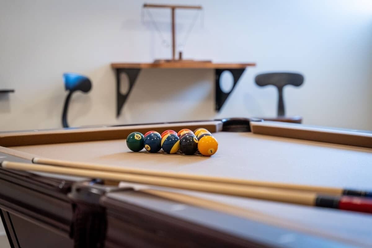 A pool table with a set of billiard balls arranged in a line.