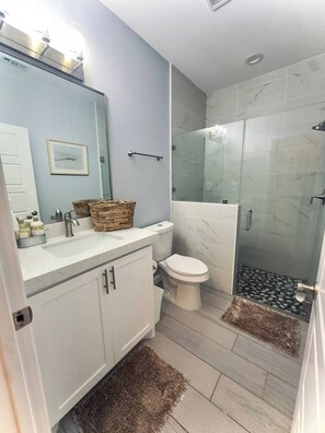 Shower, towels, soap, toilet paper