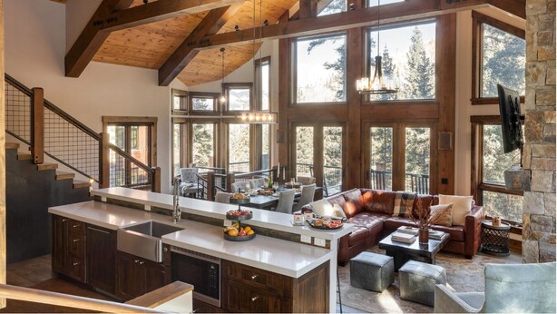 A spacious kitchen with a large island, wooden beams, and large windows offering views of the outdoors. - Apex - Walk to Trails + Hot Tub | Sauna & Theater (Mountain Village)