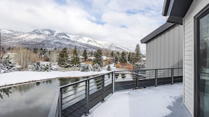 A balcony with a view of a snow-covered landscape and mountains.