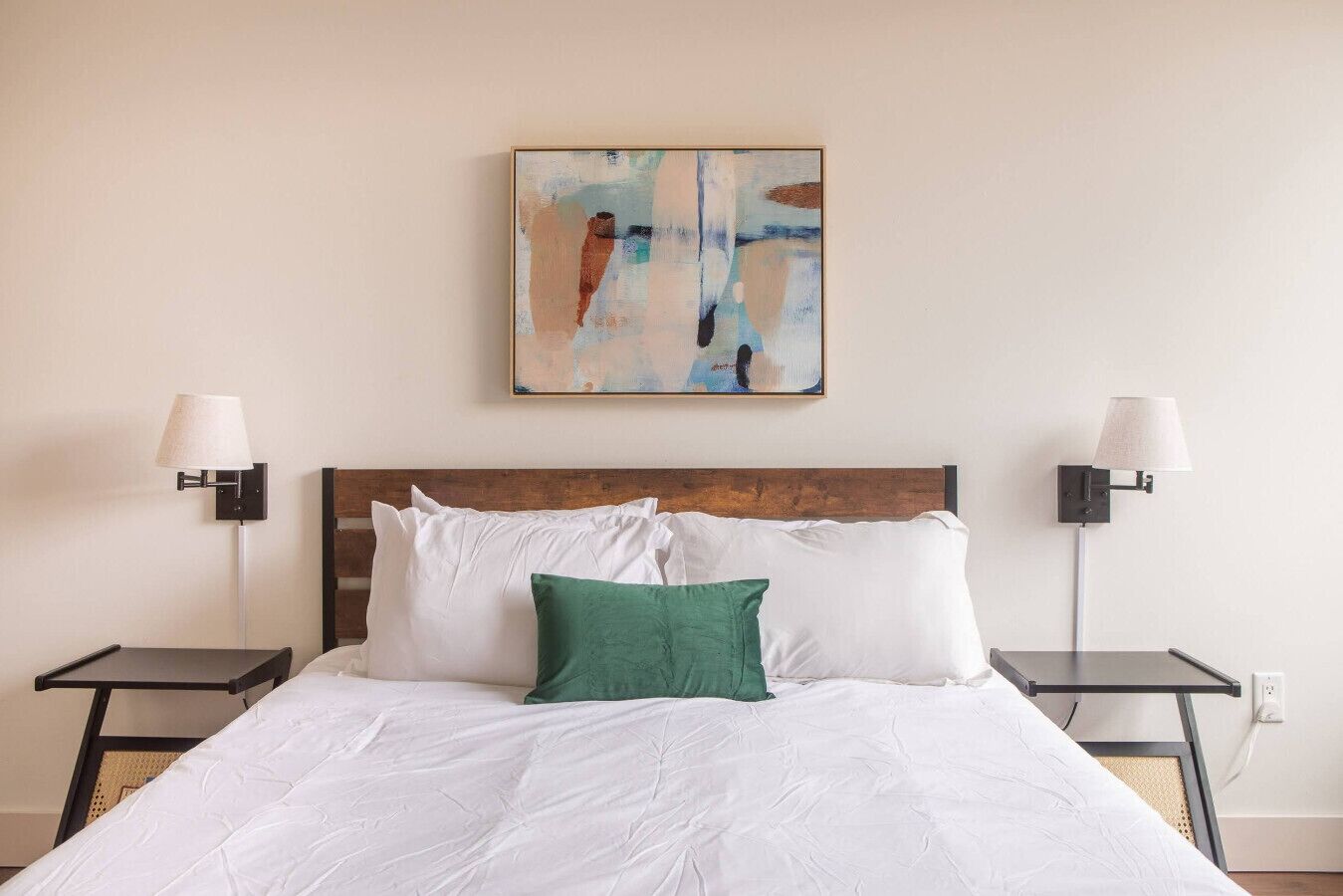 Rest easy in the primary bedroom featuring a plush queen-size bed, ample natural light, and a private ensuite bathroom