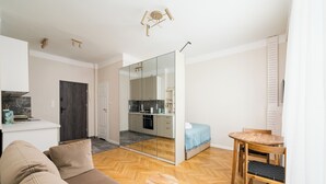 A modern apartment with a living room, a dining area, and a kitchen.