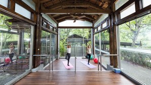 A spacious indoor area with wooden beams and large windows, allowing natural light to enter. - Butterfly Valley Resort by Cosmos Otium (Wanrong)
