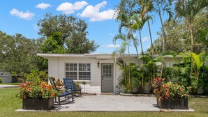 A single-story house with a front porch, a small garden with potted plants, and a bench. - 3401 W San Juan St Tampa FL 33629 USA (Tampa)