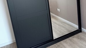 A sliding door with a black frame and a light-colored interior. - Jessi`s Harz Apartment (Sankt Andreasberg)