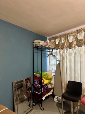 A dorm-style room with bunk beds, a chair, a mirror, and a radiator. - Equipped apartment Excellent location Ecatepec (Ecatepec de Morelos)