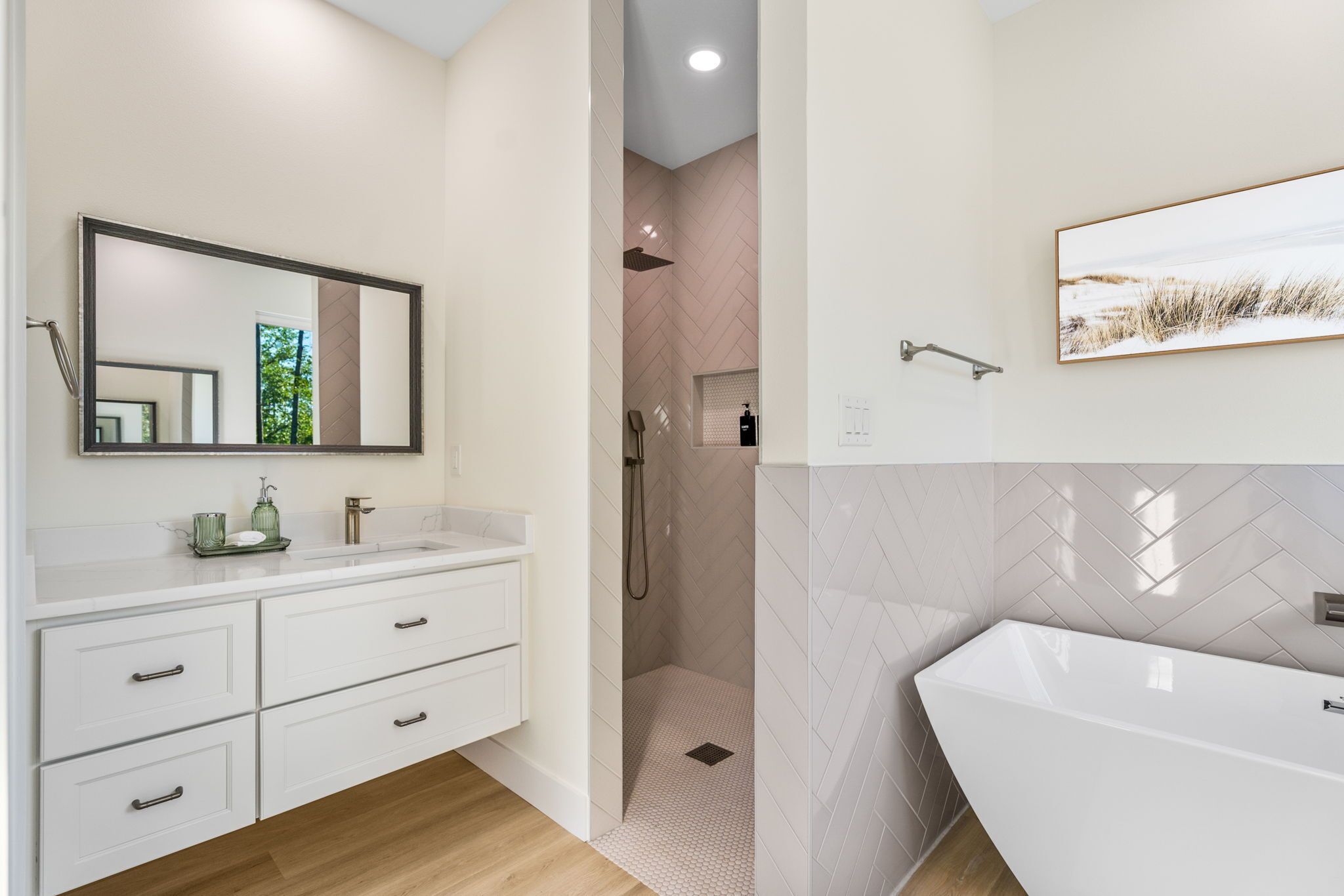 A modern bathroom with a large mirror, a freestanding bathtub, and a shower area.