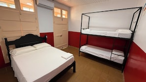 A room with a single bed, a bunk bed, and a wardrobe. - HOSTEL MANGUEIROSA (Belem)