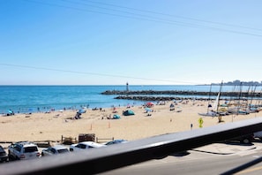 A beach with boats, tents, and cars. - Newly Renovated Ocean View Home (Santa Cruz)