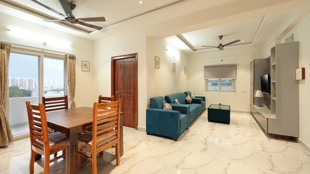 A modern living room with a dining area, a sofa set, a TV, and a ceiling fan. - Enjoyable building with AC in vibrant Hyderabad (Hyderabad)