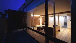 A modern interior with a wooden floor, a staircase, and a seating area. - Linca (Zushi)