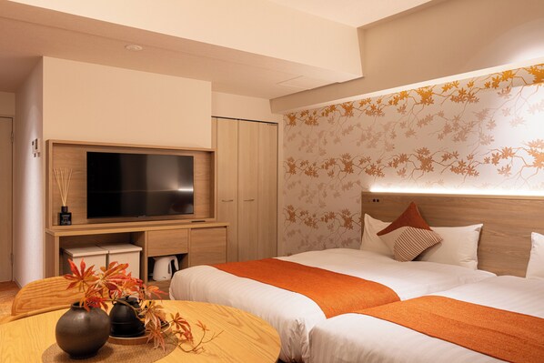 A modern hotel room with two beds, a flat-screen TV, a wooden cabinet, and a decorative wall.
