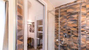 A modern bathroom with a shower area featuring geometric patterned tiles. - Caracciolo in Naples (Naples)
