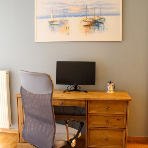 A room with a wooden desk, a chair, and a computer monitor. - Filoxenia in the Centre of Kalamata (Kalamata)