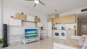 A modern apartment with a living area, kitchen, and a balcony. - Cozy Getaway With Pool in Riviera del Sol - Ref 99 (Mijas)