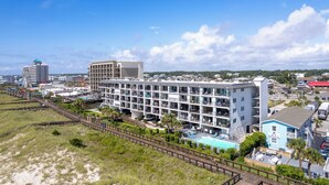 A multi-story hotel with a pool, located near a beach and a boardwalk. - Carolina Beach Condo w/ Marina View, on Boardwalk (Carolina Beach)