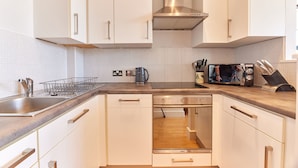 A modern kitchen with white cabinets, stainless steel appliances, and a wooden countertop. - Low Friars in Newcastle Upon Tyne (Newcastle-upon-Tyne)
