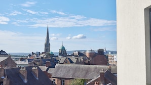 A cityscape with a prominent church spire and a dome, surrounded by traditional buildings. - Low Friars in Newcastle Upon Tyne (Newcastle-upon-Tyne)