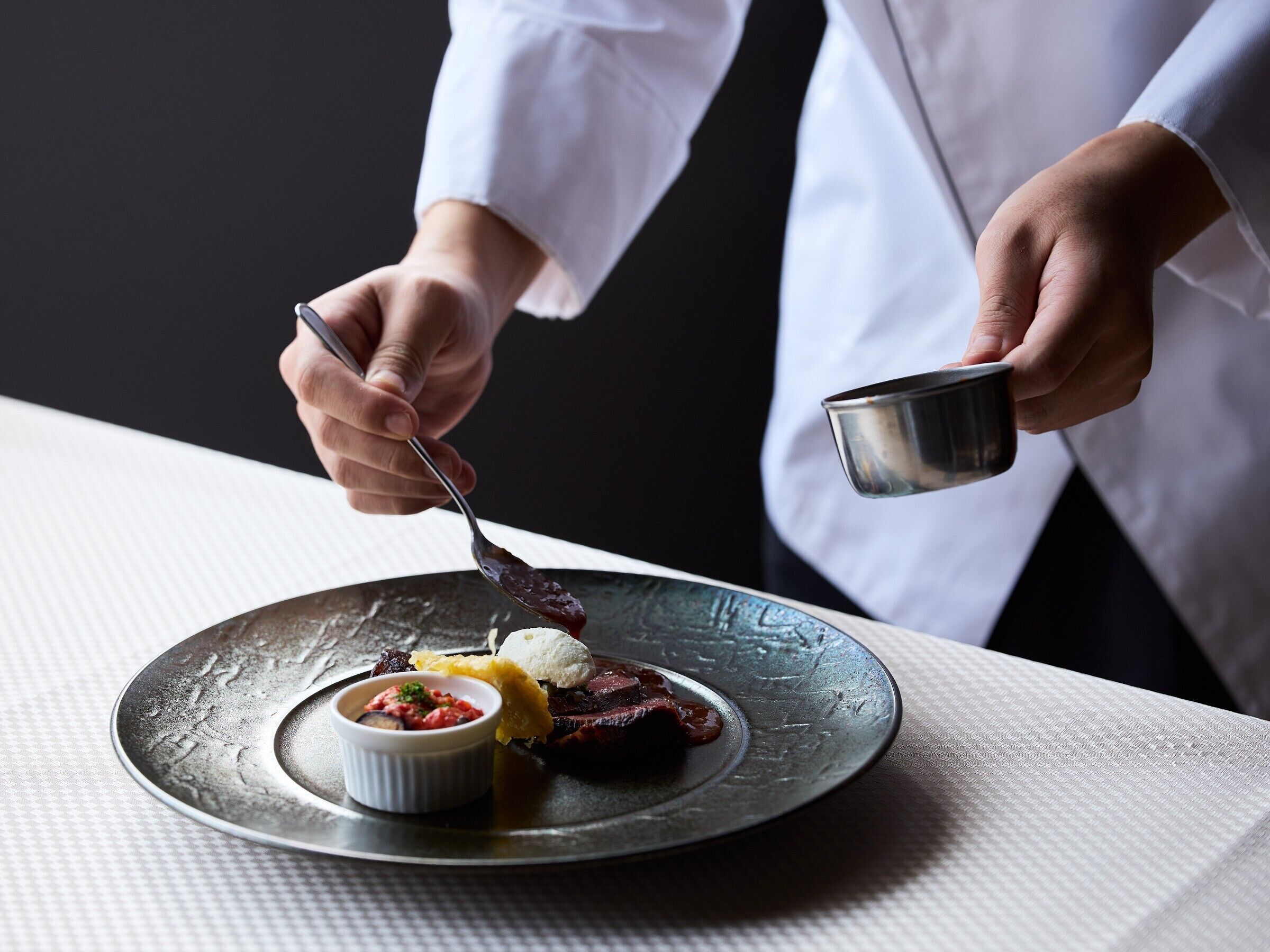 A person serving food on a plate.