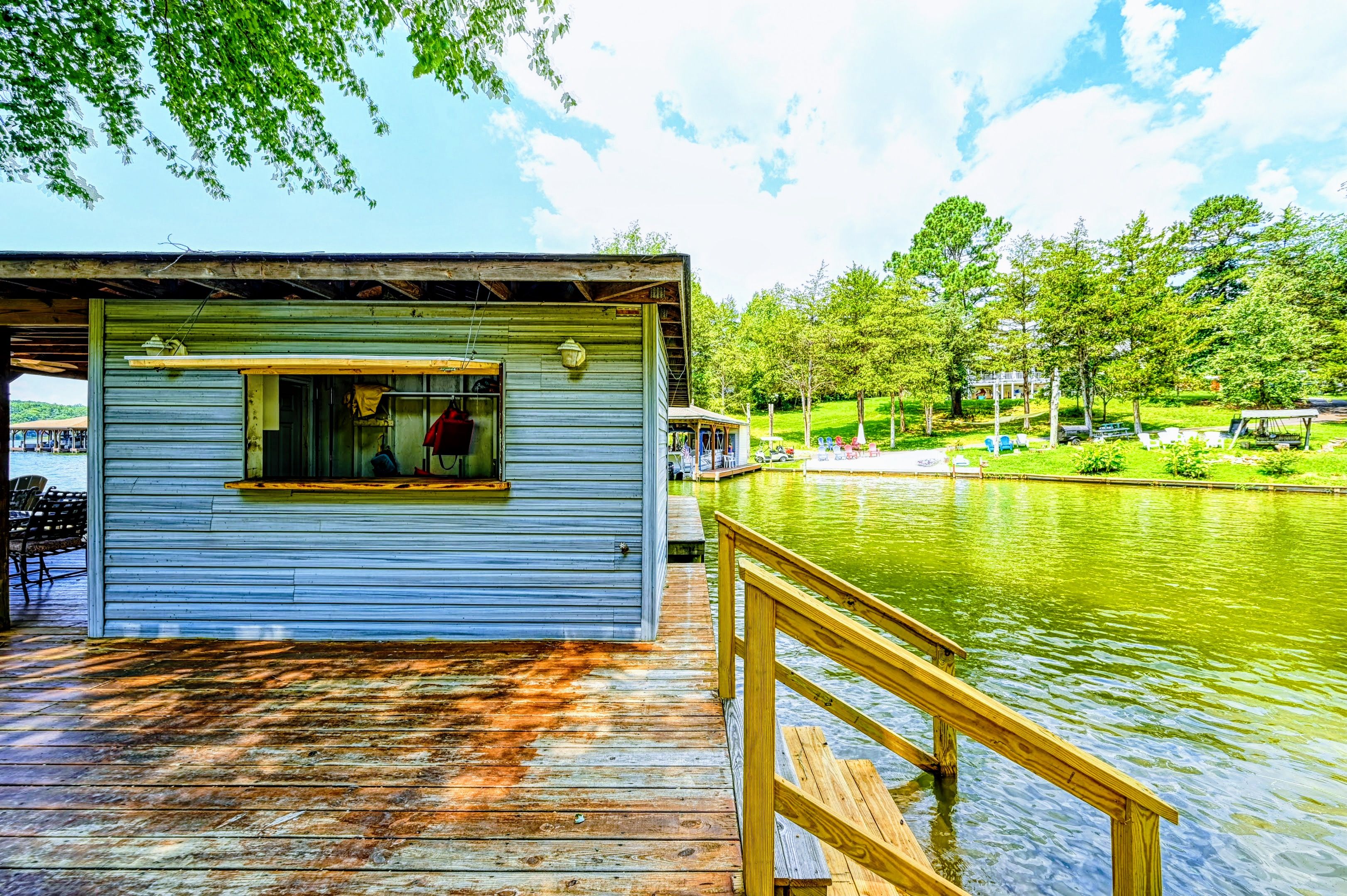 Dock - Storage shed and wood railing at the water's edge with dock access.