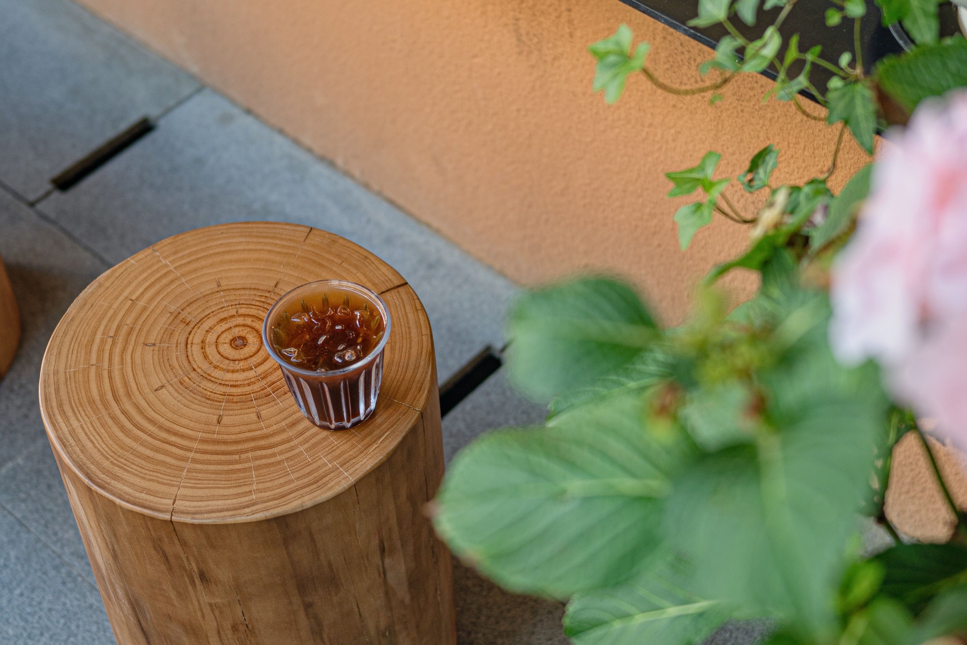 A wooden stool with a glass of jam.