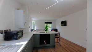 A modern kitchen with a built-in microwave, a dishwasher, and a sink.