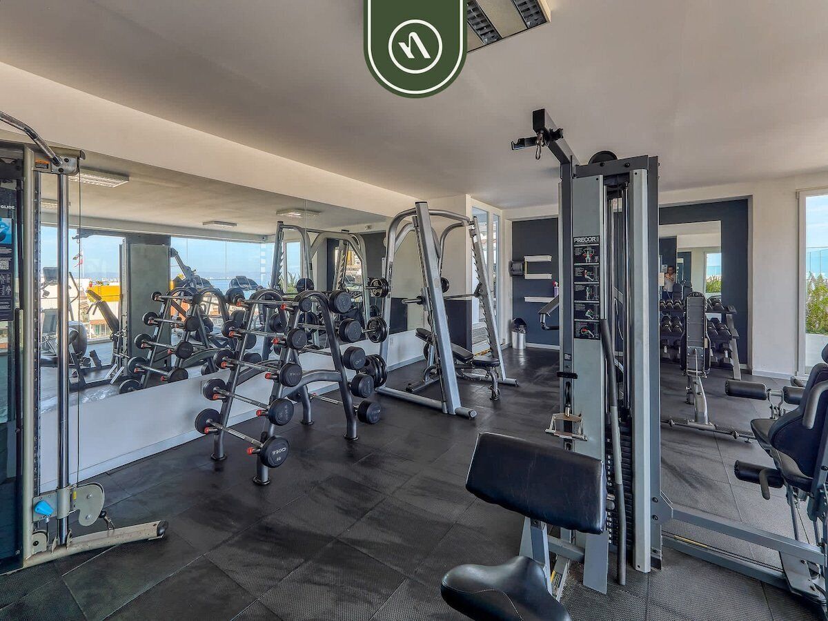 A gym with various exercise equipment, including weight machines and free weights.