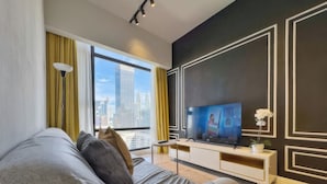 A modern living room with a large window, a flat-screen TV, and a minimalist design. - Axon Residence by Emily in Town (Kuala Lumpur)