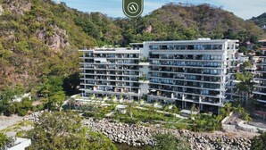 A multi-story hotel with a modern design, located in a mountainous area with lush greenery. - Oasis-810 | 1BR/1BA Puerto Vallarta | Pool & Gym (Puerto Vallarta)