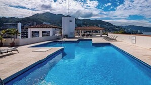 A rooftop swimming pool with a view of mountains and a cityscape. - 805-VistadelSol | 2BR/2BA PV, beach, pool, AC (Puerto Vallarta)