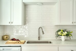 Fridge, stovetop, dishwasher, coffee/tea maker