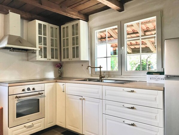 Réfrigérateur, un four, cafetière-théière, vaisselle et ustensiles