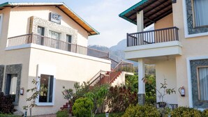 A two-story building with a stone facade, a balcony, and a staircase leading to the upper floor. - Kudrat Resort : Jim Corbett (Chauk Patelia)