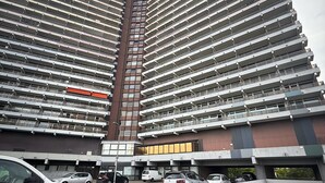 A high-rise building with multiple floors, featuring a parking area and apartment units on the same level. - City Center Retreat/ 1 min Train Station (Köln)