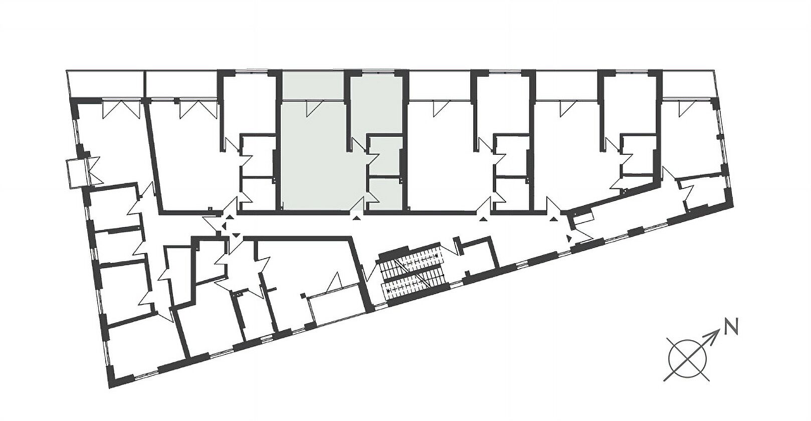 A floor plan of a building with multiple rooms and a central open area.