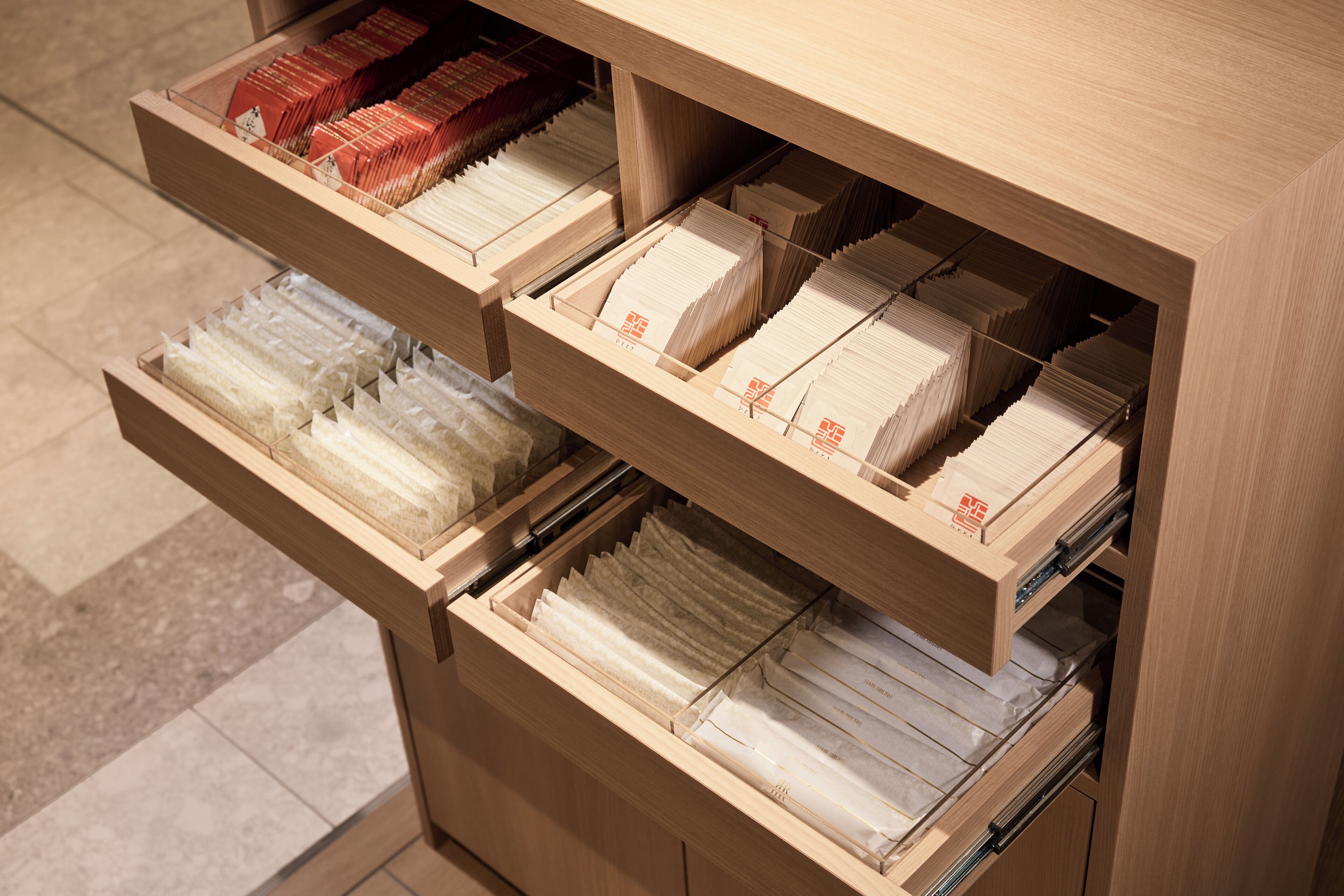 A wooden filing cabinet with multiple drawers containing neatly organized files.