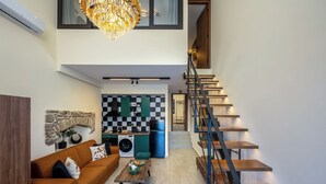 A modern interior with a staircase, a kitchen area, and a living room. - Symi's Jewel (Simi)