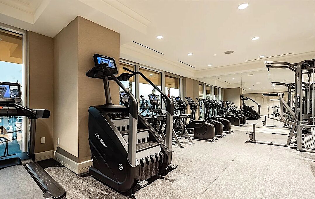 A gym with treadmills, ellipticals, and weight machines.