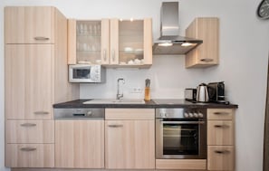 Fridge, stovetop, dishwasher, coffee/tea maker