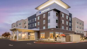 A modern hotel with a flat roof, multiple floors, and a prominent entrance. - Hyatt House Fresno Campus Pointe (Fresno)