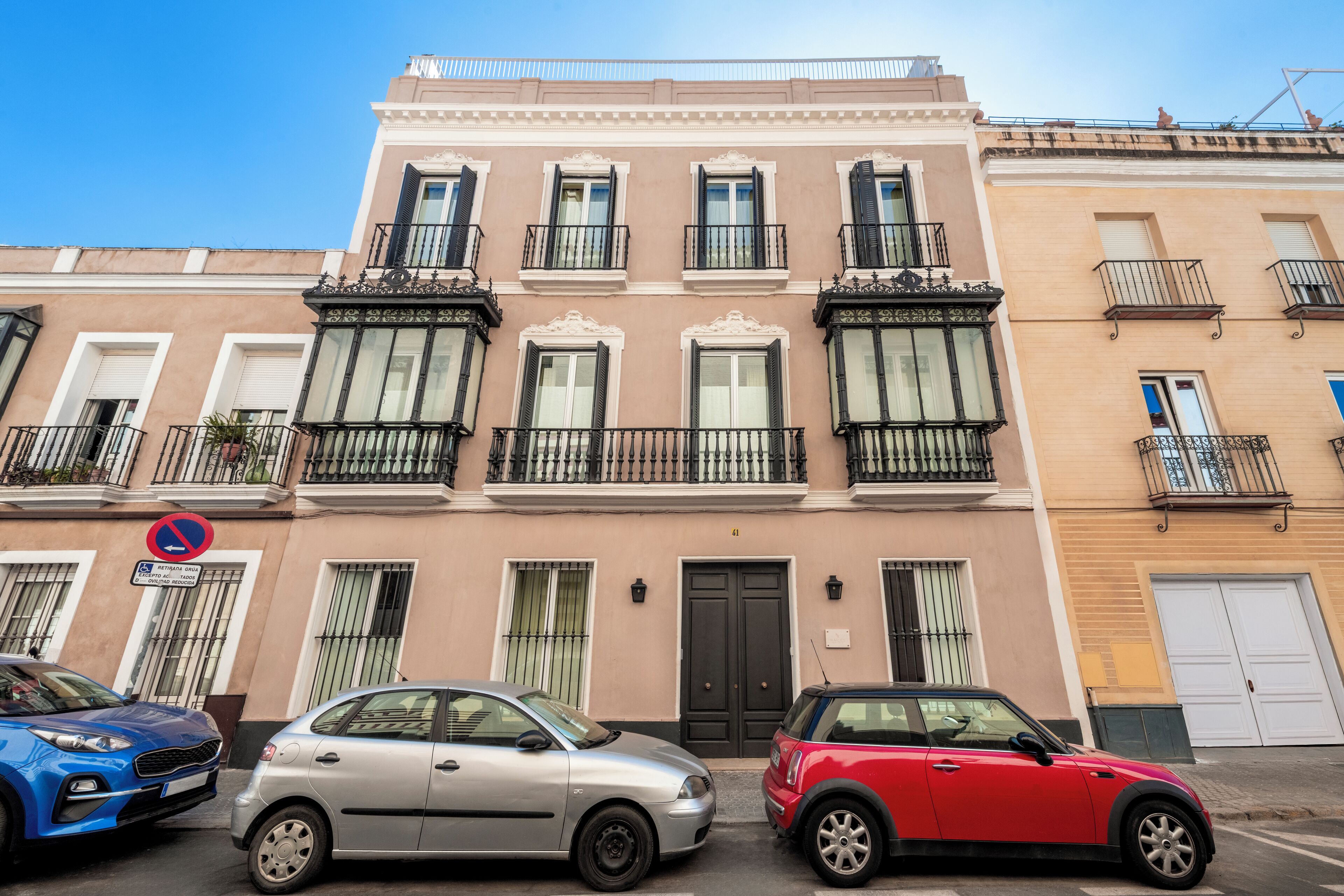 A building with a classic architectural style, featuring a symmetrical facade with evenly spaced windows and balconies.
