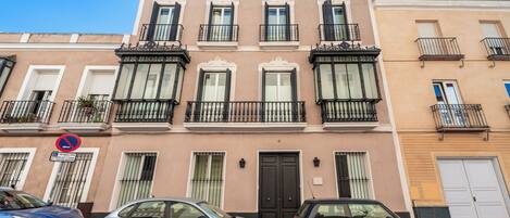 A building with a classic architectural style, featuring a symmetrical facade with evenly spaced windows and balconies.