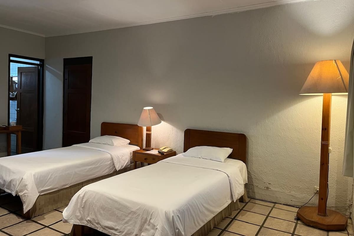 Standard Twin Room, Garden View | Desk, laptop workspace, free WiFi, bed sheets